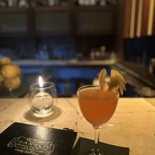 a cocktail and a menu