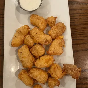 WISCONSIN CHEESE CURDS hand-breaded Wisconsin cheddar curds, buttermilk ranch