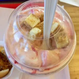 a cup of ice cream with a spoon sticking out of it