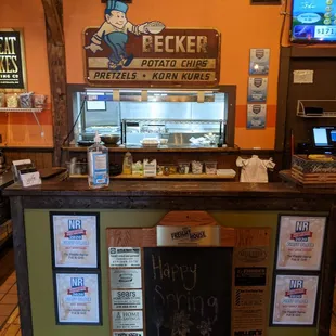 Host stand with window into kitchen.