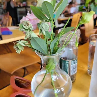 a vase of flowers and sunglasses