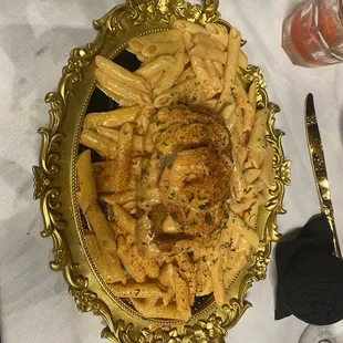 Cajun Fish and shrimp pasta on a mirrored jewelry tray