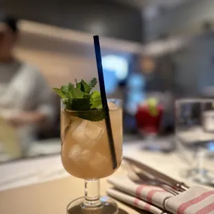 a drink with a straw and mint