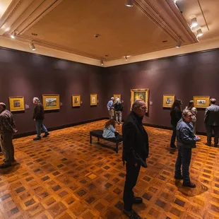 Guests explore an exhibition in the Frick Art Museum