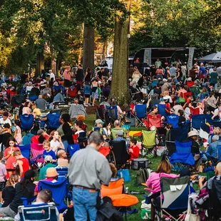 A crowd of visitors enjoy a concert at a Summer Friday at The Frick
