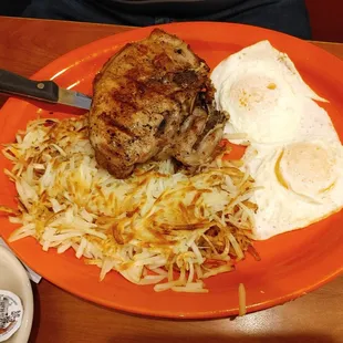 Pork chops, hash browns, eggs over med and toast.