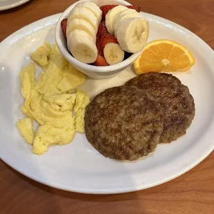 Scrambled eggs, sausage and fruit