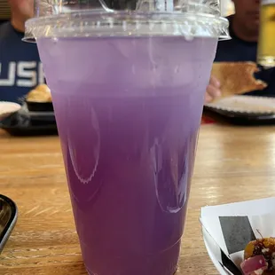a purple drink in a plastic cup
