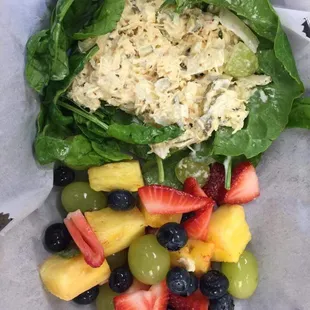 a salad with spinach and fruit