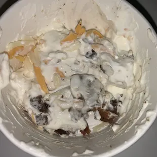 Half full baked potato dip after 2 chips were eaten from it.