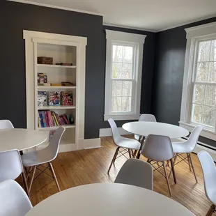 a dining room with white tables and white chairs