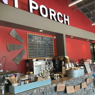 a coffee shop with a menu on the wall