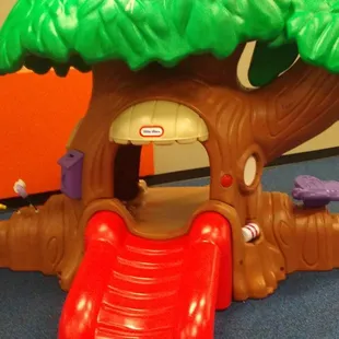 a tree house with a slide