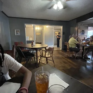 a woman sitting at a table with a drink