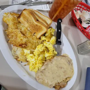 Tenderloin with gravy, toast, scrambled eggs, hash browns ,  unsweetened tea.