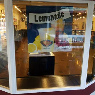 a lemonade sign in a store window
