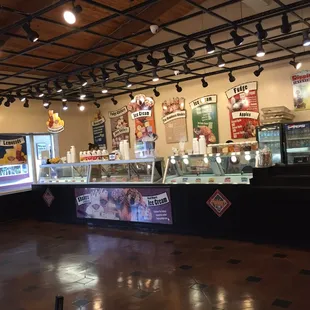 a restaurant counter with a variety of food items