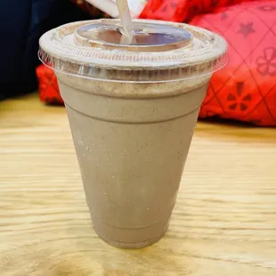 a plastic cup with a straw