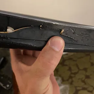 a hand holding a piece of metal