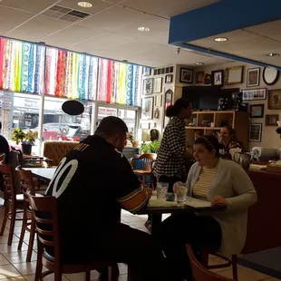 people sitting at tables in a restaurant
