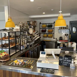 Front counter, pastries, fruit, register