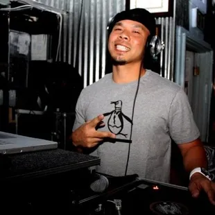 a dj with headphones and a laptop