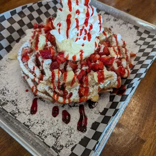 Strawberry Cheesecake Funnel Cake with vanilla ice cream