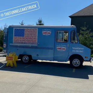 a blue truck parked in a parking lot