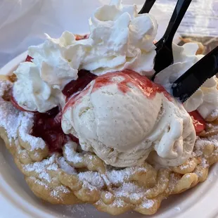 Funnel Cake Sundae (Fundae) topping with strawberry banana and ice cream: horchata and strawberry cheesecake