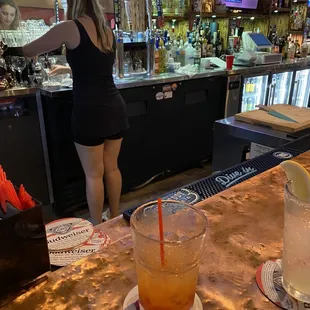 a woman standing at a bar