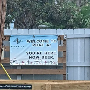 a welcome sign on a fence