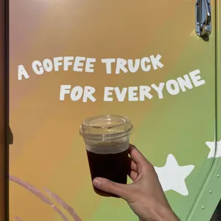 a hand holding a cup of coffee