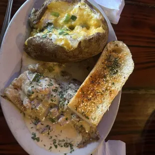 Grilled grouper with crawfish sauce and baked potato