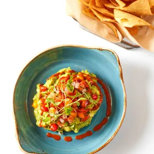 a bowl of guacamole and chips