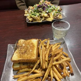 a plate of fries and a grilled cheese sandwich