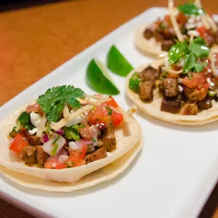 two tacos on a white plate