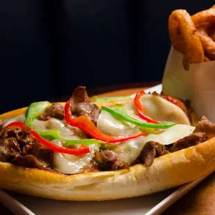 a sub sandwich and onion rings