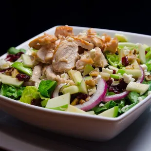 a bowl of salad with chicken and vegetables