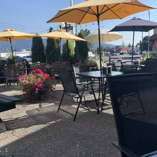 tables and chairs with umbrellas