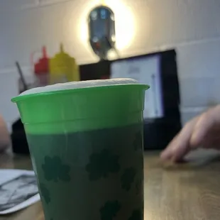 Good beer in a green cup for St Patrick&apos;s Day