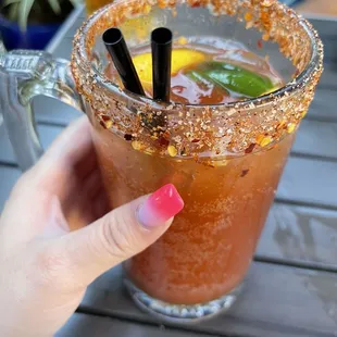 a person holding a bloody drink