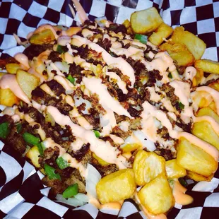 a plate of food with fries and sauce