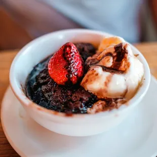 a bowl of chocolate pudding with strawberries