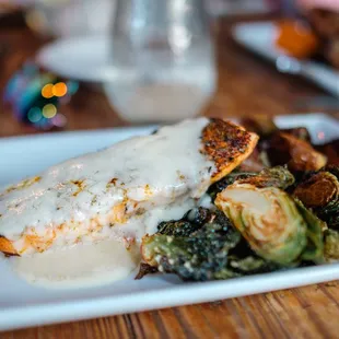 a plate of chicken with gravy and brussels sprouts