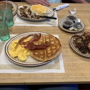 Belgian waffle meal with side of red skin potatos, Country eggs Benedict with side of pancakes(which are huge btw)