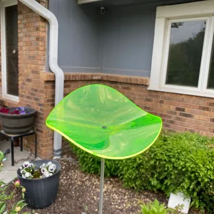 A greenish yellow garden decoration.  These look as if they are illuminating when it&apos;s sunny.