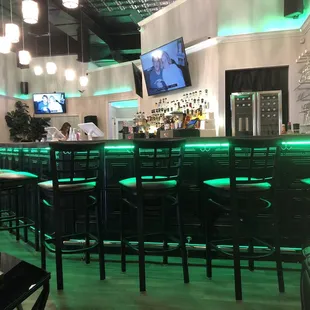 a bar with green lights
