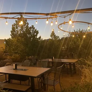 a patio with tables and chairs