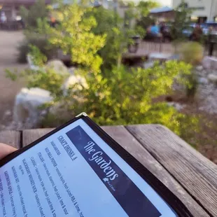 a hand holding a tablet