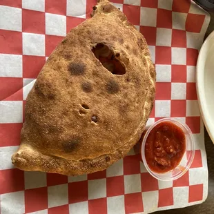a plate of pizza and a bowl of ketchup
